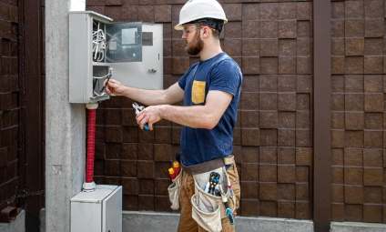 Eletricista realizando manutenção em caixa de energia