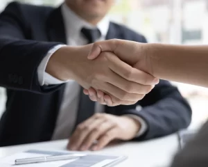 foto profissional apertando a mão de outra pessoa iniciando o mercado de trabalho